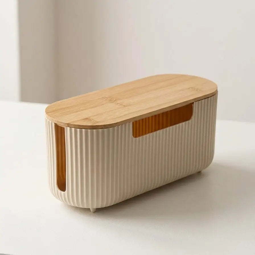 Boîte de rangement pour câbles beige au design cannelé.