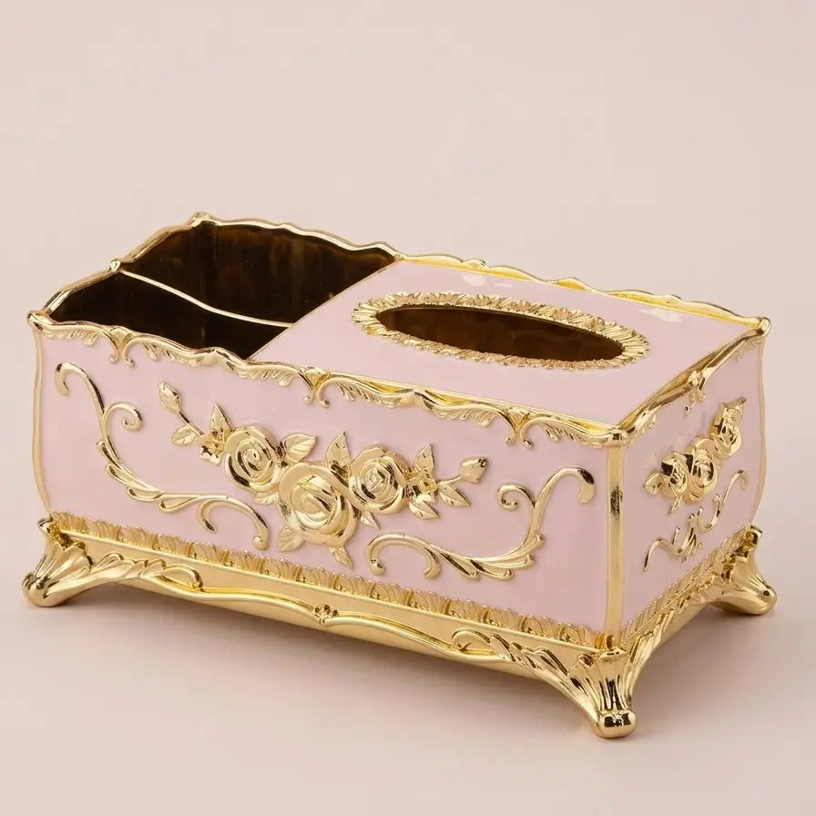 Boîte à mouchoirs rose et dorée avec reliefs décoratifs baroques.